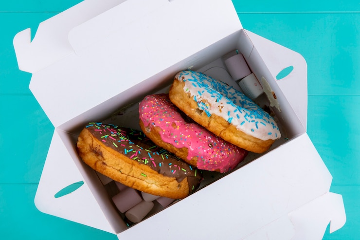 Free Photo top view of colored sweet donuts in a box on a turquoise surface