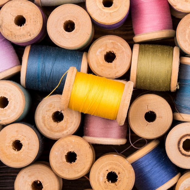 Free photo top view of colored thread spools