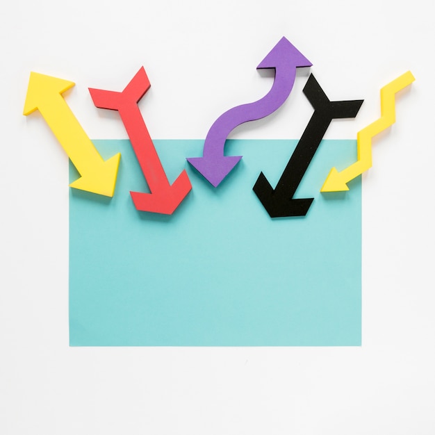Top view colorful arrows and blue cardboard on white background