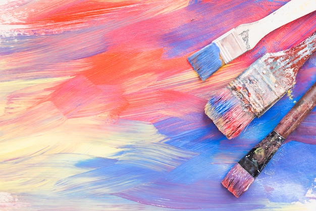 Top view of colorful brushstroke and dirty paint brushes