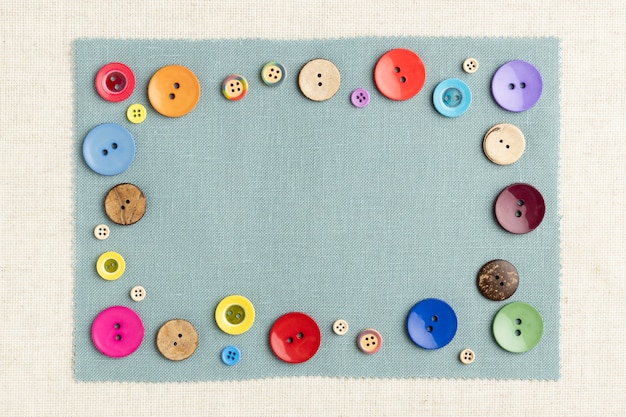 Free photo top view colorful buttons on cloth