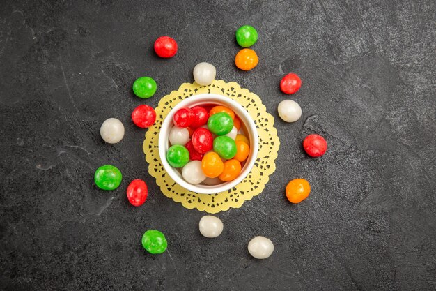 top view colorful candies on dark background color rainbow sweet tea