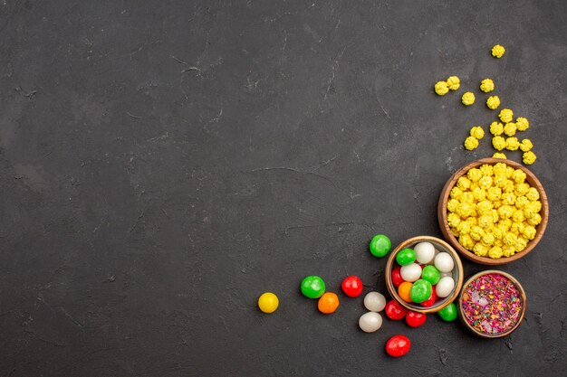 Top view colorful candies on dark space