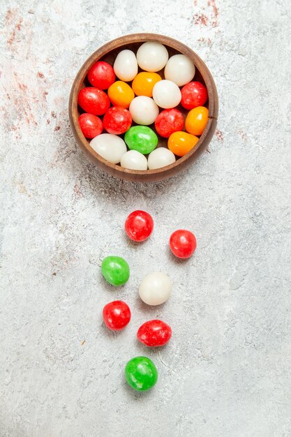 Top view colorful candies on white desk color candy sugar rainbow