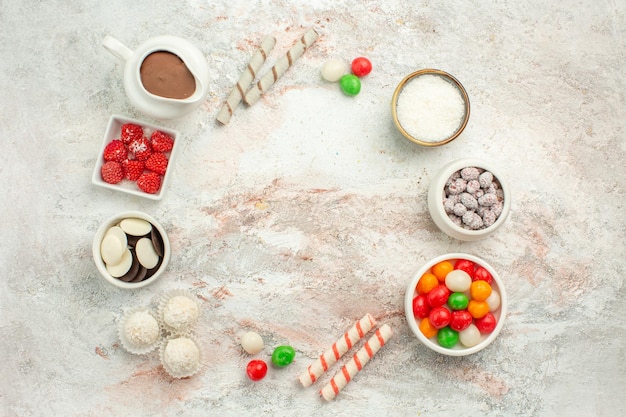 Vista dall'alto caramelle colorate con biscotti su sfondo bianco biscotto torta dolce biscotto