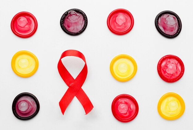 Top view colorful condoms on white background