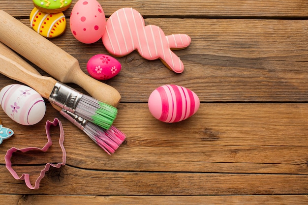 Top view of colorful easter eggs with copy space and kitchen utensils