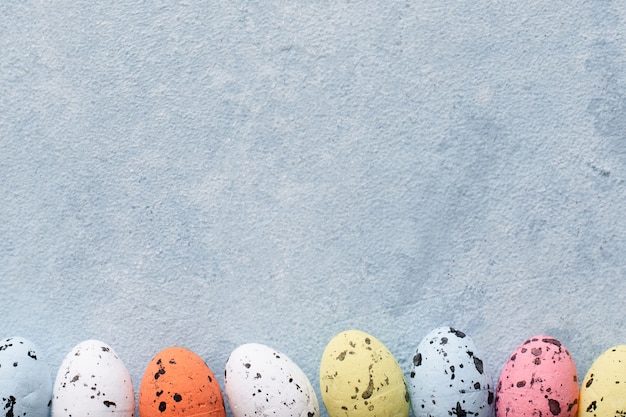 Free photo top view colorful easter eggs with copy space