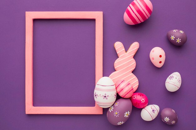 Top view of colorful easter eggs with frame and bunny