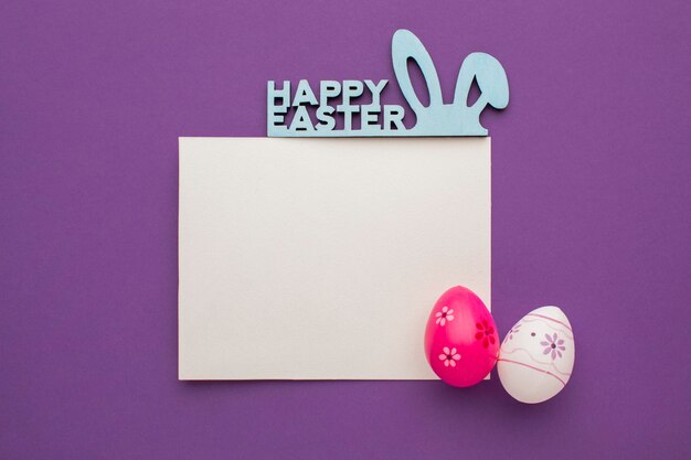 Top view of colorful easter eggs with greeting and bunny