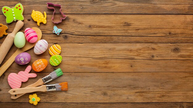 Top view of colorful easter eggs with kitchen utensils and copy space