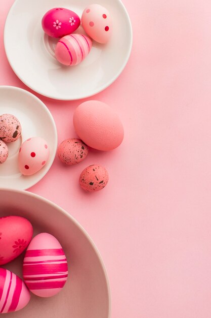 Top view of colorful easter eggs with plates