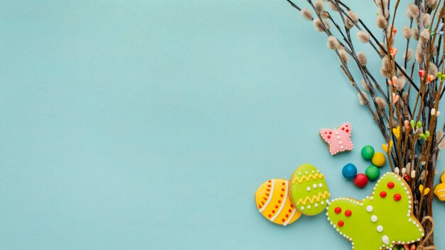 Top view of colorful easter eggs with twigs and copy space