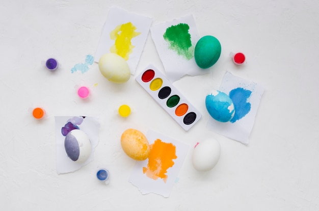 Top view of colorful eggs and palette for easter