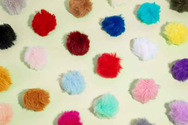 Top view on colorful and fluffy pom poms