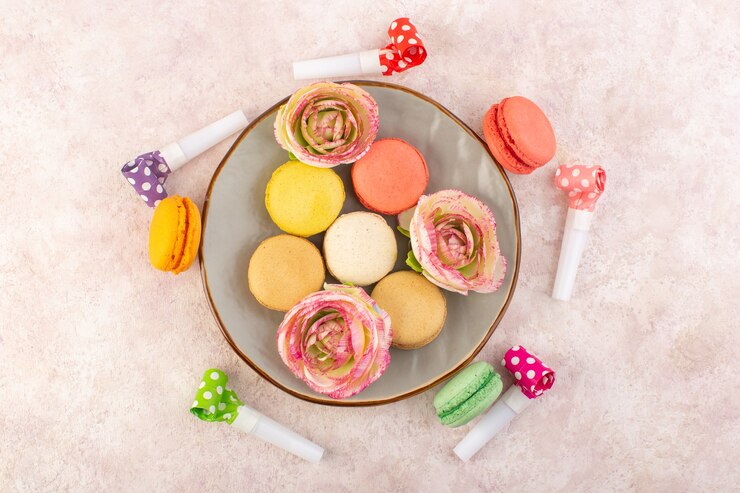 Free Photo a top view colorful french macarons on the pink desk sugar cake biscuit sweet