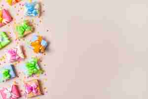 Free photo top view colorful gifts on table with pink background