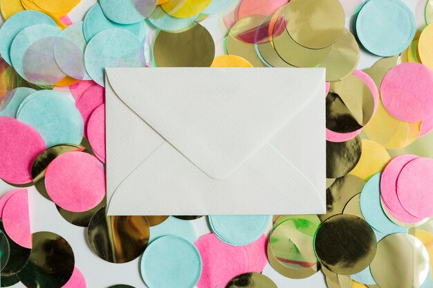Top view colorful golden confetti with envelope