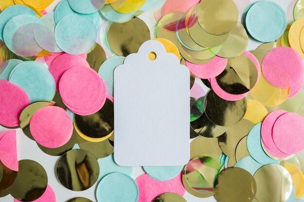 Top view colorful golden confetti with label