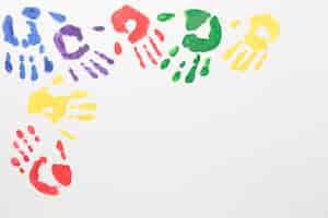 Free photo top view colorful hands on white background with copy space