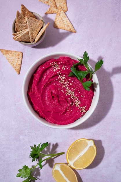 Top view over colorful hummus with ingredients