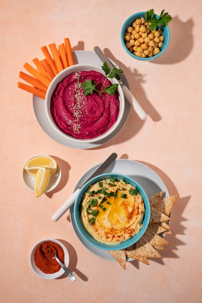 Top view over colorful hummus with ingredients