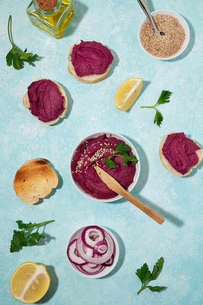 Top view over colorful hummus with ingredients