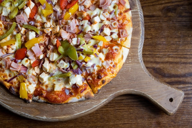 Top view of a colorful Italian pizza with various ingredients