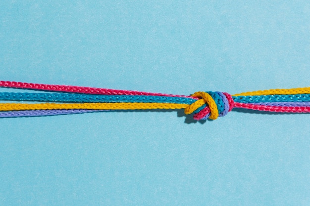 Top view colorful knot on blue background