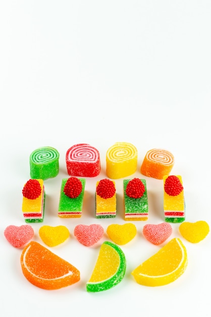 A top view colorful marmalade confitures sticky and delicious lined on white, color sugar sweet confectionery