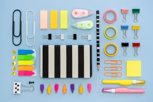 Top view of colorful office stationery with paper clips and tape