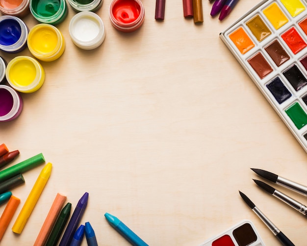 Top view of colorful paint on desk concept