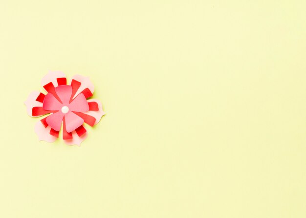 Top view of colorful paper spring flower with copy space