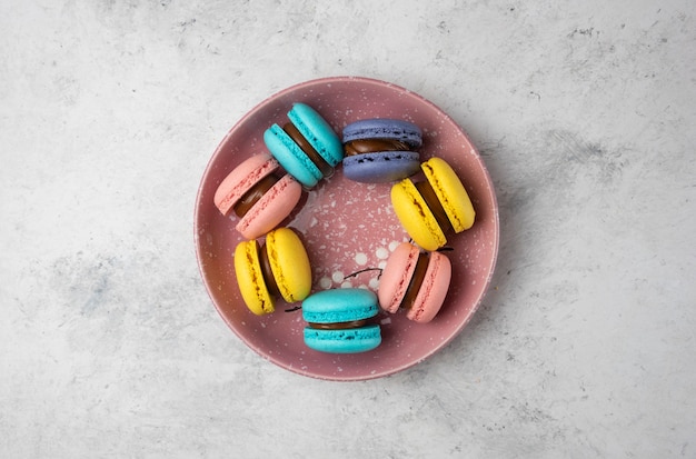 Top view of colorful pastel macarons on white background. 