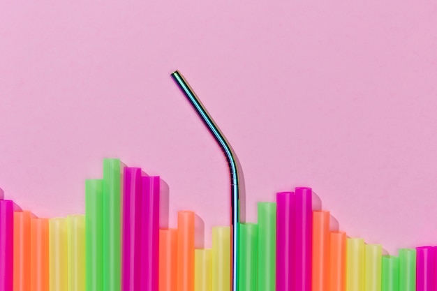 Top view of colorful plastic straws mixed with metal