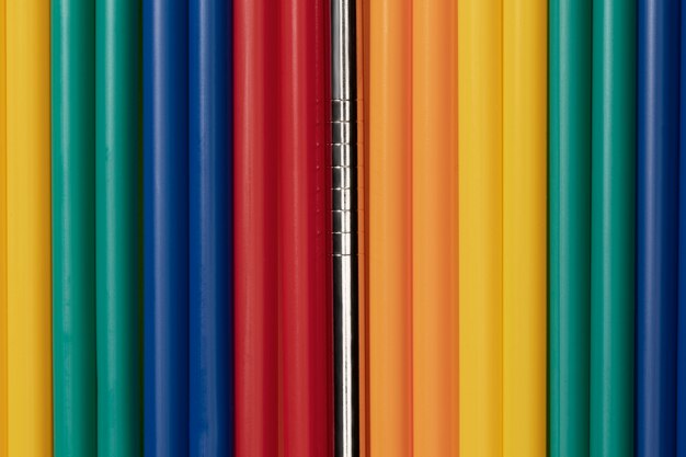 Top view of colorful plastic straws mixed with metal