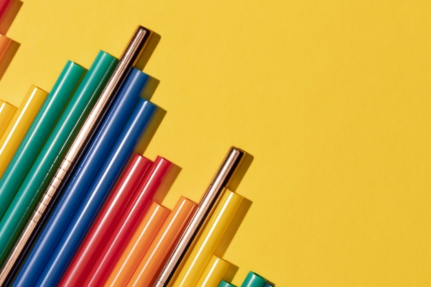 Top view of colorful plastic straws mixed with metal