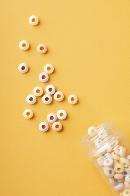 Top view of colorful round candy with transparent jar