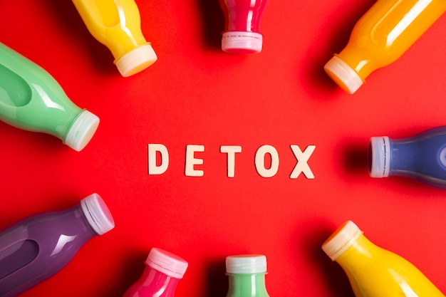 Top view colorful smoothies with detox lettering