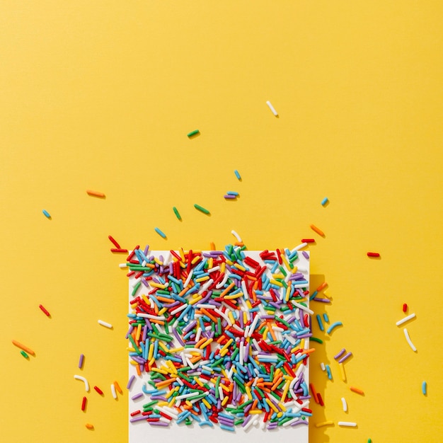Top view of colorful sprinkles on photo with copy space