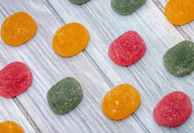 Top view of colorful tasty marmalade candies scattered on rustic