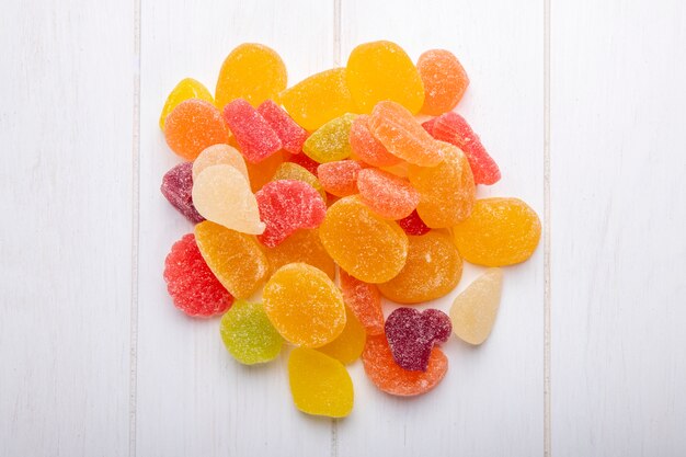 Top view of colorful tasty marmalade candies scattered on rustic