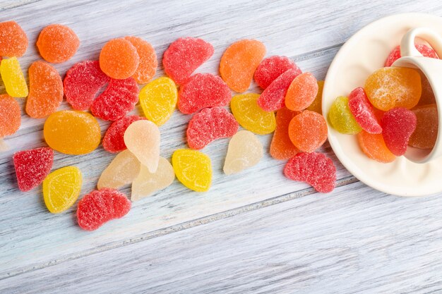 Top view of colorful tasty marmalade candies scattered on rustic