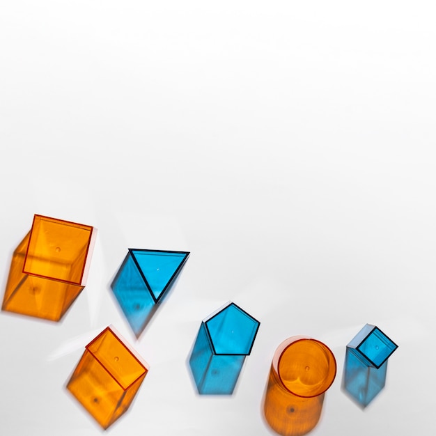 Top view of colorful translucent shapes with copy space