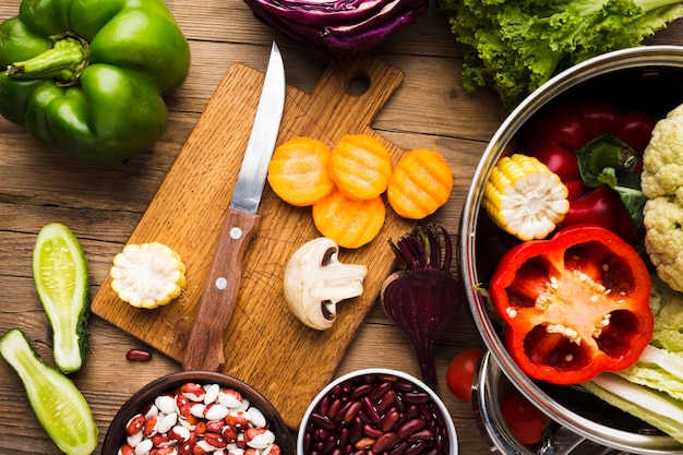 Top view colorful vegetables assortment on wooden background