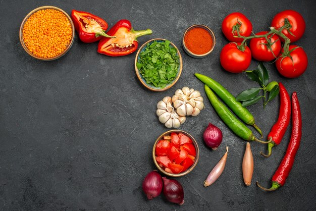 Top view of colorful vegetables lentil in bowl next to the colorful vegetables and spices