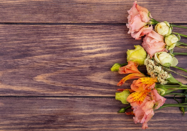 Top view of colorful wonderful and different flowers on wood