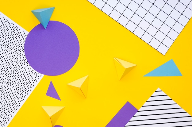 Top view of colourful paper pyramids and cut-outs