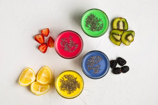 Top view colourful smoothies in glasses