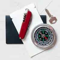 Free photo top view compass, key and knife